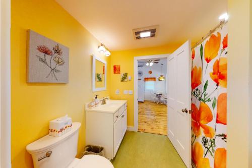 a bathroom with a white toilet and a sink at Rising Tide Cottage in Cushing