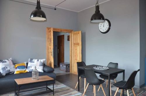 a living room with a couch and a table at Nowy Rynek 10 in Płock
