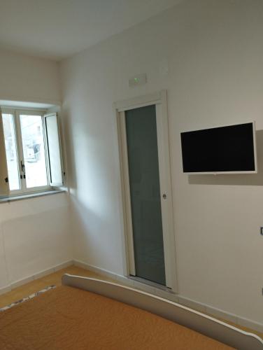 a room with a flat screen tv on the wall at La Bomboniera B&B Amalfi coast in Vietri sul Mare