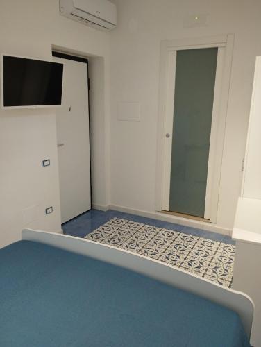 a room with a bed and a mirror at La Bomboniera B&B Amalfi coast in Vietri sul Mare