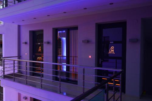 a balcony of a building with purple lights at Panorama Inn Hotel in Paralia Katerinis