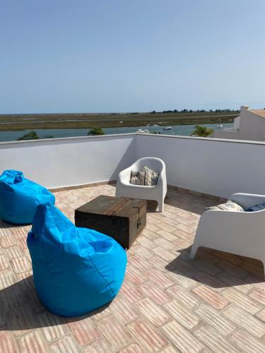 a room with chairs and tables on a roof at A Casa Azul in Santa Luzia