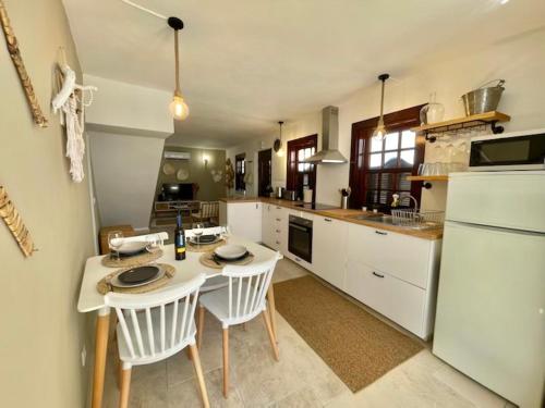 a kitchen with a table and chairs in a kitchen at RIVER SUN in Valada