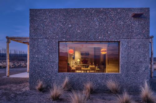 a stone house with a window on the side of it at Lodge Atamisque in San José