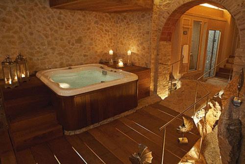 a large bathroom with a tub in a room at Hotel Sa Calma in Begur