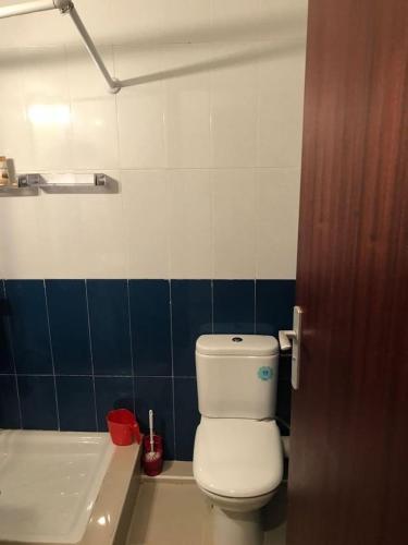 a bathroom with a white toilet and a sink at résidence à Fnideq plage in Fnidek