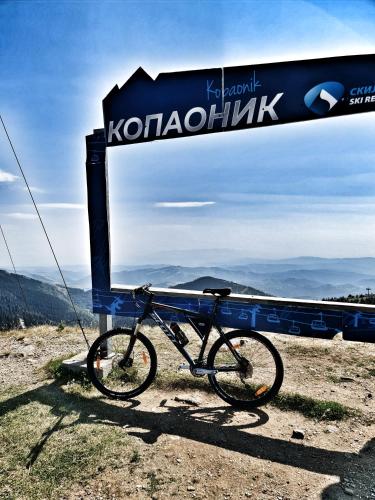 a bike parked next to a sign on a mountain at Milmari S70 Kopaonik in Kopaonik