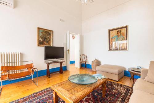 a living room with a table and a tv at Dimora Blu by BarbarHouse in Cerfignano
