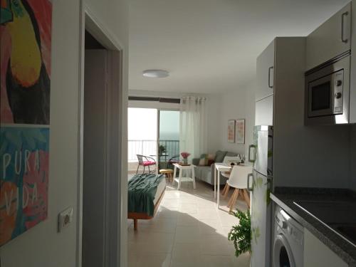 a kitchen and living room with a view of a living room at Over Open Sea Apartment in Icod de los Vinos