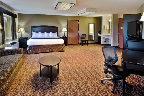a hotel room with a bed and a couch at AmericInn by Wyndham Beaver Dam in Beaver Dam