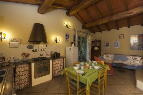 a kitchen with a table with a green table cloth at Il Chicco d'Oro in Massarosa