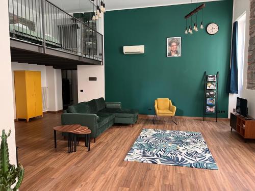 - un salon avec un canapé vert et une table dans l'établissement OpenSpaceMonti82 a pochi passi dal Duomo di Como, à Côme