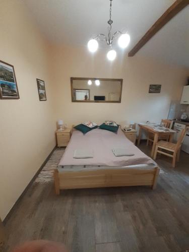 a bedroom with a large bed and a table at Apartament Beata in Karpacz