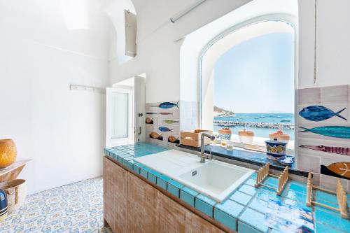 a bathroom with a sink and a window at Casa Gastronomo in Procida