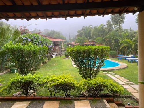 a view of a yard with a swimming pool at La Dolce Vita in Mulungu