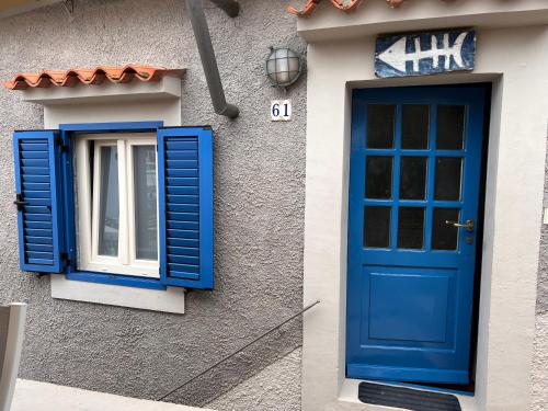 a blue door and a window on a house at Valun 61 in Valun
