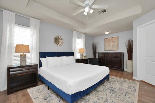 - une chambre avec un lit et un ventilateur de plafond dans l'établissement Early Green Neighborly Home, à Houston