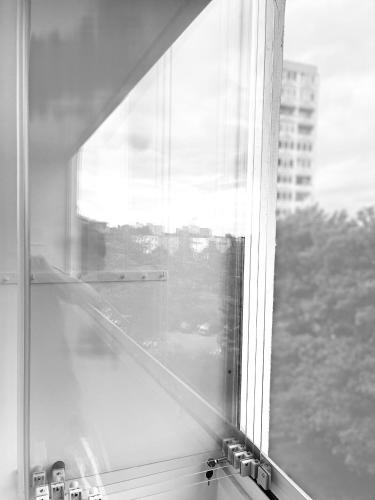 an open window with a view of a city at ne-doma in Chomutov