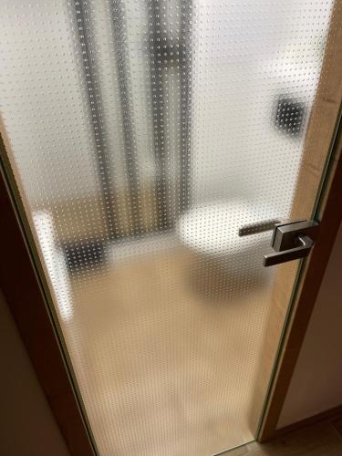 a bathroom with a glass door with a toilet at ne-doma in Chomutov