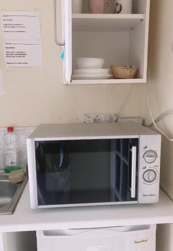 a microwave oven sitting on a counter in a kitchen at Mulgrave Lodge in Dun Laoghaire
