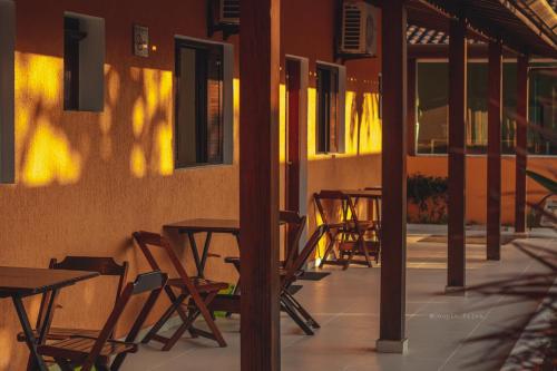 a group of tables and chairs on a patio at Pousada Acqua Bella PISCINA CLIMATIZADA in Bertioga