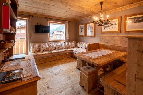 a living room with a couch and a table at Neve e Sole in Selva di Val Gardena