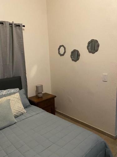 a bedroom with a bed and a clock on the wall at Casa Praxedis in Santiago