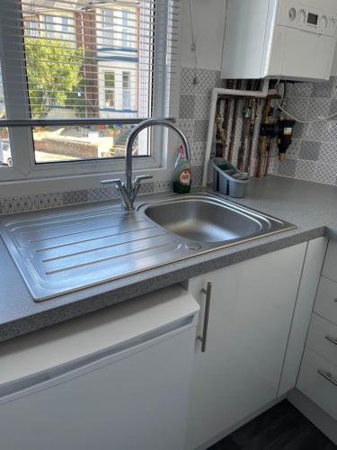 a kitchen counter with a sink and a window at H &P accommodation in Plymouth