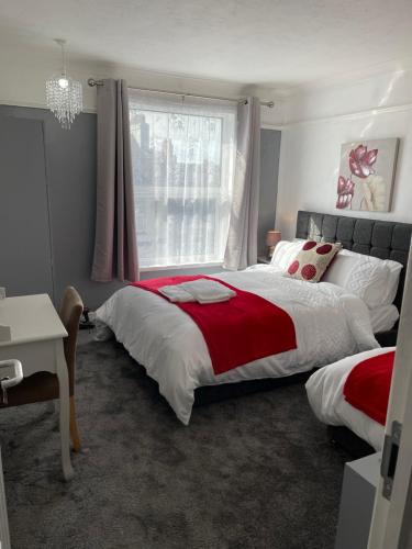 a bedroom with two beds and a window at H &P accommodation in Plymouth