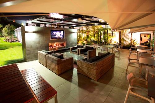 a living room with couches and a fireplace at Commodore Airport Hotel Christchurch in Christchurch