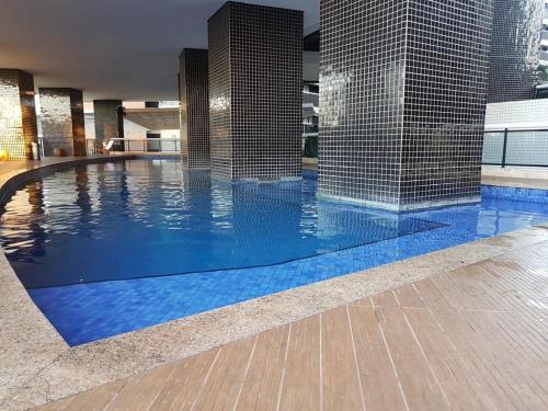 a swimming pool in a building with blue tiles at Beira Mar Fortaleza Landscape in Fortaleza
