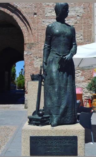 a statue of a woman holding a baseball bat at AVA-2 in Arévalo