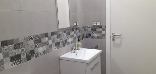 een witte badkamer met een wastafel en een spiegel bij LOFT FRIOL in Friol