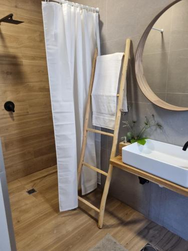a bathroom with a towel rack next to a sink at בית בעמק in Merhavyāh