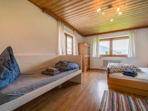 a bedroom with a bed and a large window at Ferienhaus Schlitters in Schlitters