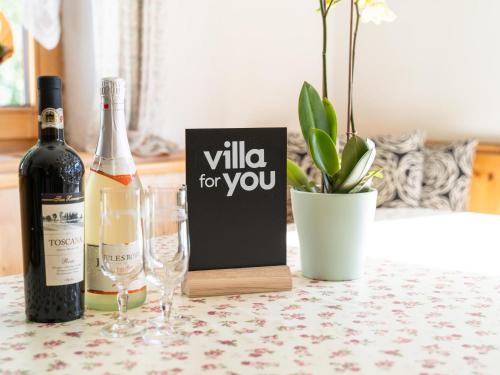 a bottle of wine and two glasses on a table at Ferienhaus Schlitters in Schlitters
