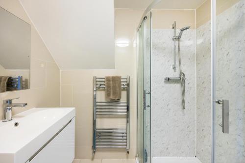 a bathroom with a shower and a sink at Verv Islington in London