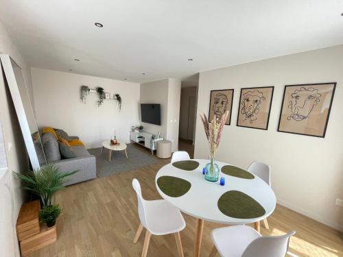 a living room with a white table and chairs at Charmant logement aux portes de Paris - STADE DE FRANCE - 12 min à pied in Saint-Denis