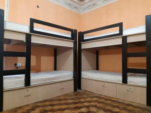a room with three bunk beds in a room at BAKU GUEST HOSTEL in Baku