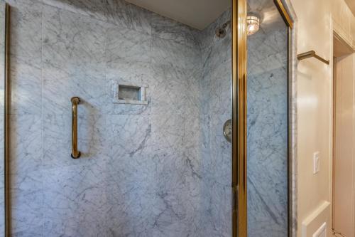 a bathroom with a shower with a glass door at Mill Rose Inn in Half Moon Bay
