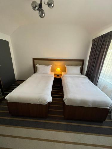two beds sitting next to each other in a room at Hotel Casa Andalucia in Hallbergmoos