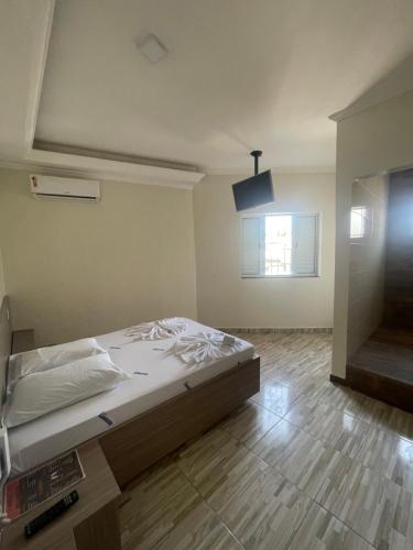 Ένα ή περισσότερα κρεβάτια σε δωμάτιο στο Hotel Aricanduva