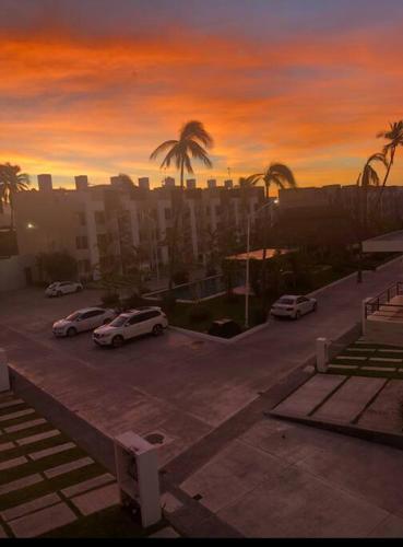 a parking lot with parked cars in a city at Nuevo penthouse con terraza privada, alberca , area infantil y pet friendly in Manzanillo