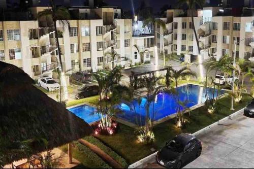 an overhead view of a large building with a swimming pool at Nuevo penthouse con terraza privada, alberca , area infantil y pet friendly in Manzanillo