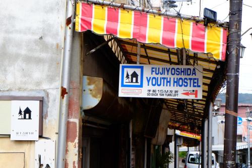 a building with a sign that reads flu epidemic youth hospital at Fujiyoshida Youth Hostel in Fujiyoshida