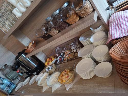 a bunch of plates and bowls on a shelf at Hotel AI Königshof in Berlin
