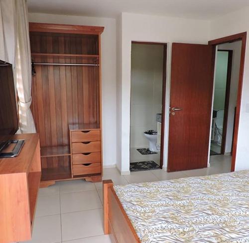 a bedroom with a bed and a dresser and a mirror at TRIPLEX SOLAR CASA BRANCA in Guaramiranga