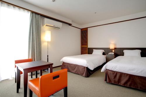 Postel nebo postele na pokoji v ubytování Hotel Resonex Naha