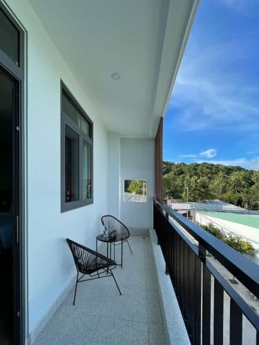 two chairs sitting on the balcony of a house at Leaf Hotel Phu Quoc in Phu Quoc