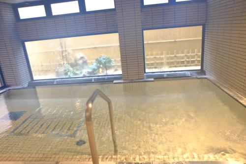 a pool of water in a room with two windows at West Inn Fuji-Yoshida in Fujiyoshida